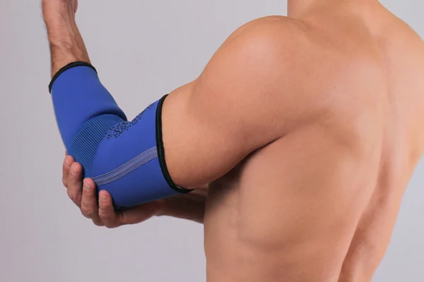 Man With Pain In Elbow. Pain relief concept