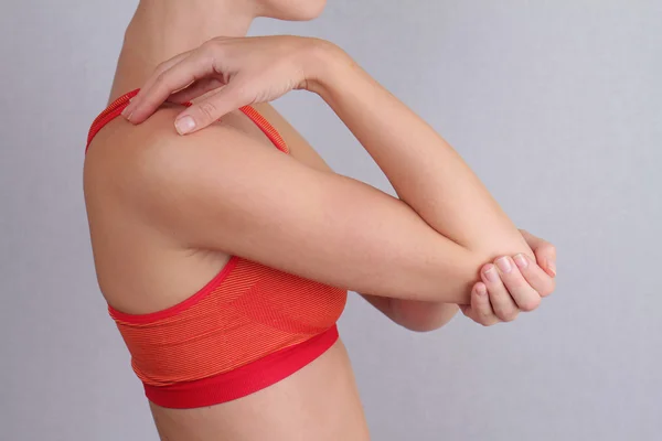 Woman With Pain In Elbow. Pain relief concept
