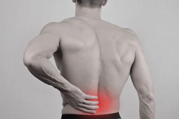 Man with neck and back pain. Man rubbing his painful back close up. Pain relief concept