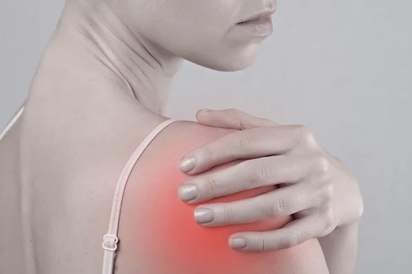 Acute pain in a woman shoulder. Pain relief concept