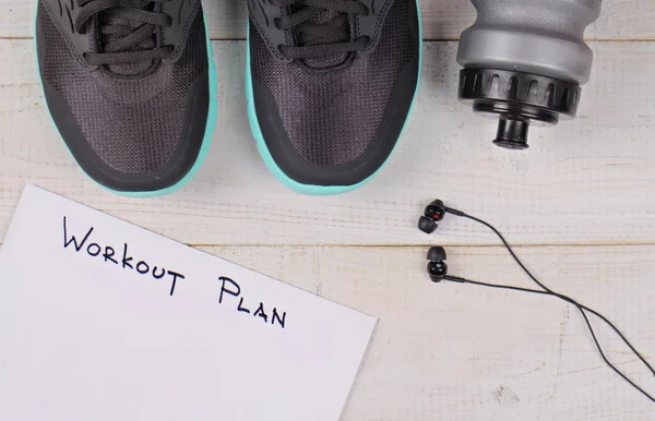 Sport, Running concept. Running shoes and workout plan on white background.