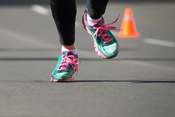 Woman running marathon detail running shoes