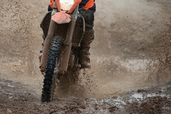 Motocross driver splashing mud