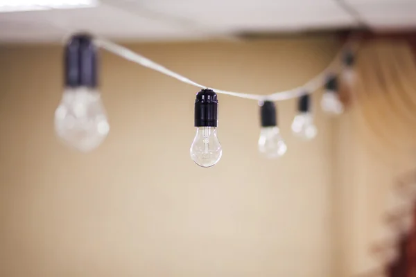 Electric bulb garland hanging indoor.