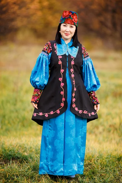 Beautiful girl in national dress smartly blue with ornaments and embroidery.