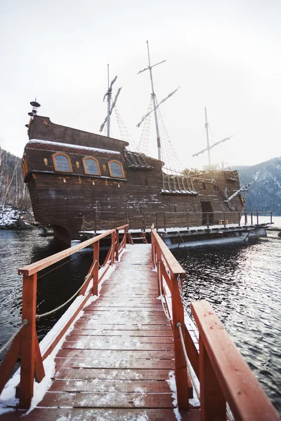 SAYANOGORSK, RUSSIA, DECEMBER 2014 - Entertainment boat for tourist trips, replica to famous Black Pearl from the movie Pirates of Caribbean docked in bay at Yenisey River, South Siberia.