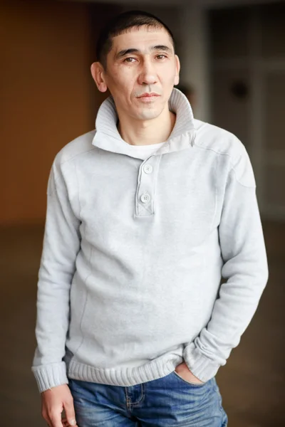 Close up portrait of middle aged man brunette in casual clothes with short hair thoughtfully looking directly into camera, the employee gets job, dressed light pullover.