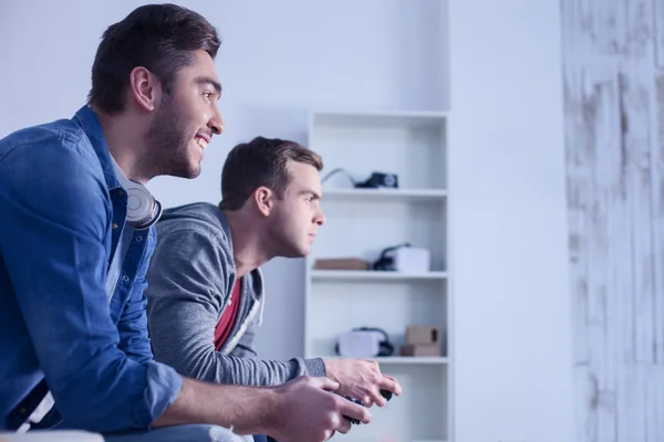 Attractive two guys are competing in play station