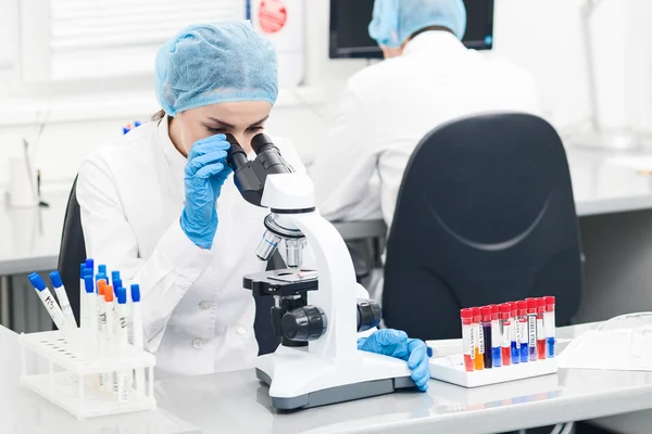 Beautiful female researcher testing substance in lab