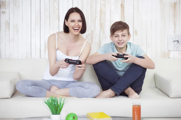 Mother and her adult son playing on console