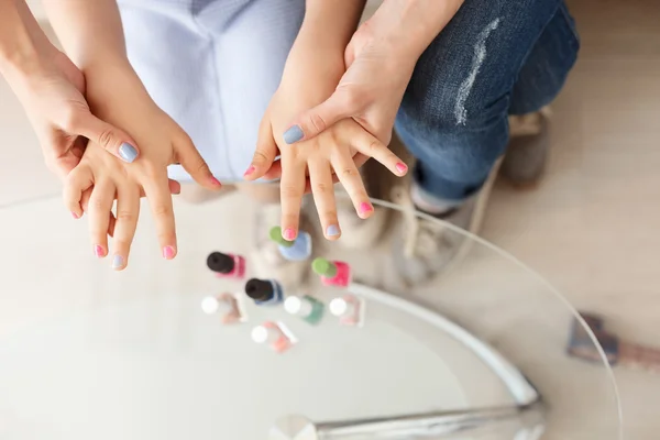 Mother and daughter doing manicure