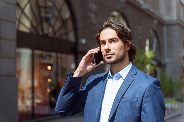Busy businessman talking on telephone