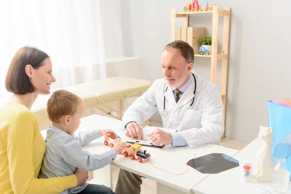 Little boy with his mother at paediatrician on consultation