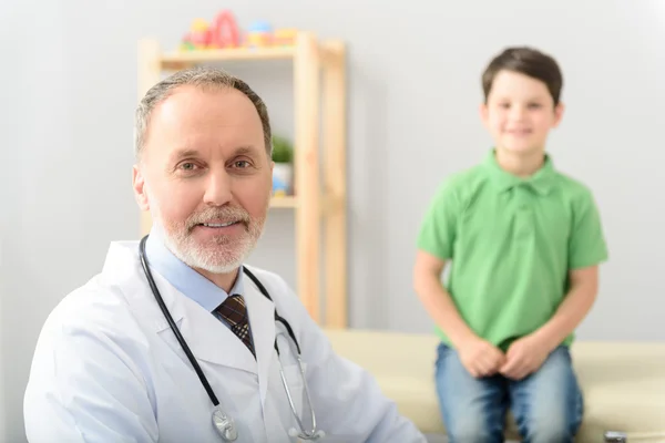 Pediatrician doctor examining small boy