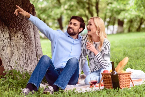 Joyful loving couple relaxing in park