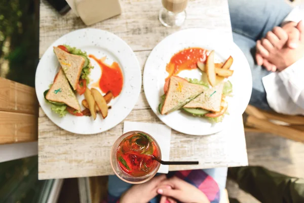 Happy friends having lunch in cafe