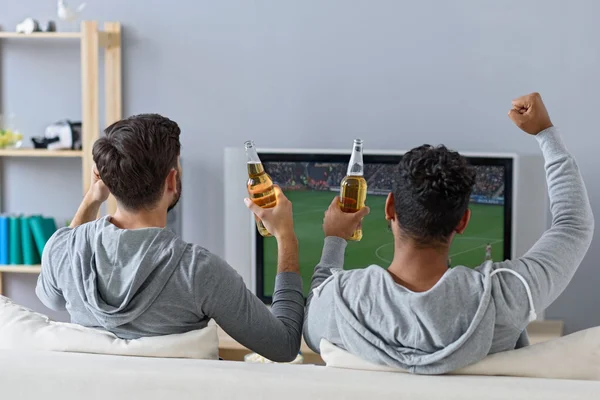 Friends enjoying soccer in TV