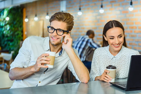 Joyful guy and girl relaxing in cafe