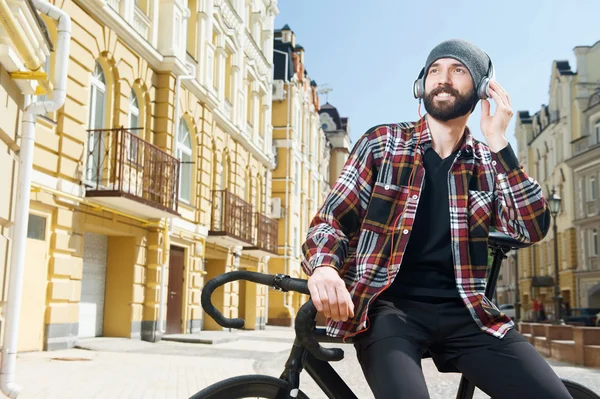 Attractive happy man is relaxing in city