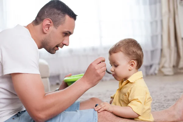 Attractive young man is caring his child