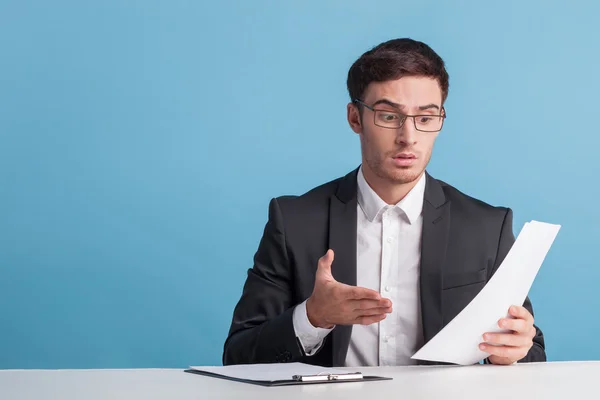 Attractive young male newscaster is telling news