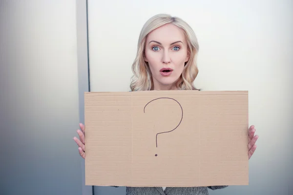 Attractive woman is presenting a placard with interrogation point