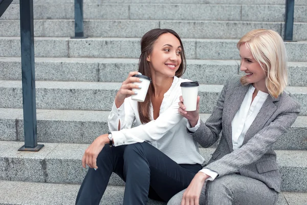 Cheerful young businesswomen are resting after work