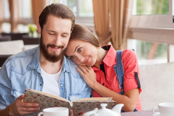 Beautiful young man and woman in restaurant