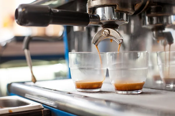 Machinery is making coffee for two cups