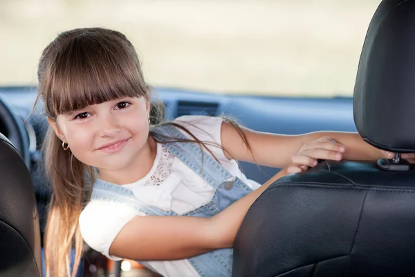 Cute female child is playing in vehicle