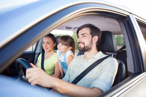 Pretty parents and child are traveling by vehicle