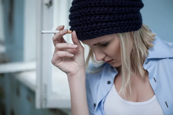 Frustrated blond female druggie has unhealthy lifestyle