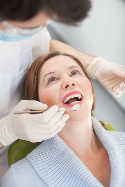 Experienced male dental doctor is treating his patient