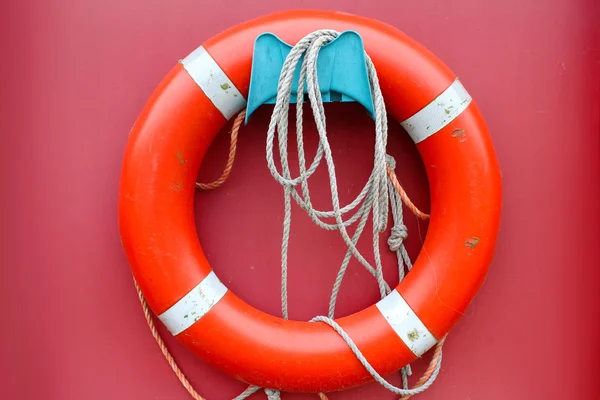 Red lifebuoy on a pink background