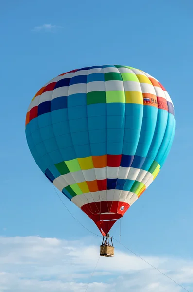 Colorful balloon on blue sky background and clouds