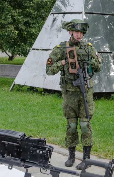 Marines in Russia camouflage and with weapons guarding a military facility.