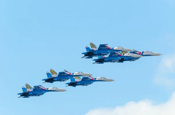 A group of six flying supersonic su-27 fighters of the aerobatic team Russian Knights at the air show in St. Petersburg. July 2015.