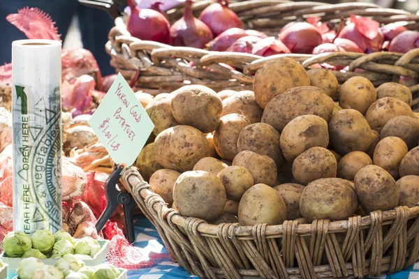 Fresh organic Yukon gold potatoes and onions at farmer\'s market