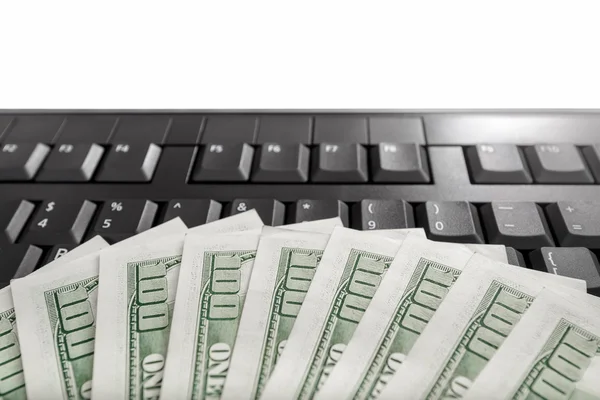 Money on computer keyboard