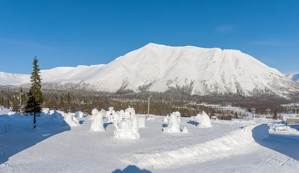 Winter view of the snow-covered mountain. In the foreground of snow sculpture.