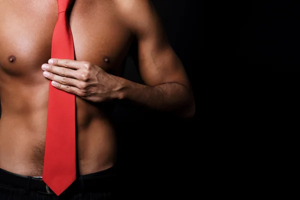 Shirtless man with red tie