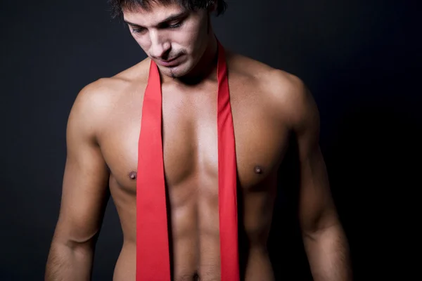 Shirtless man with red tie