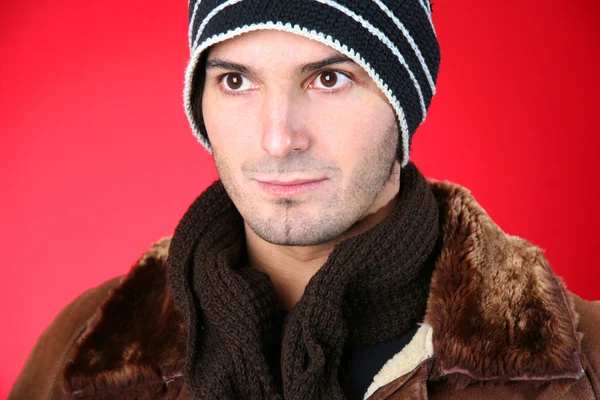 Man in a knit hat and leather jacket