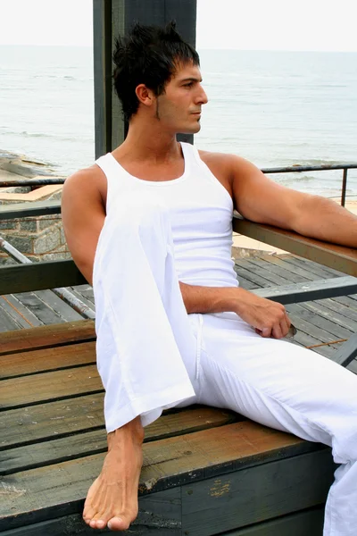 Young man relaxing on pier