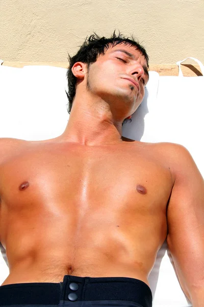 Young sexy man sunbathing