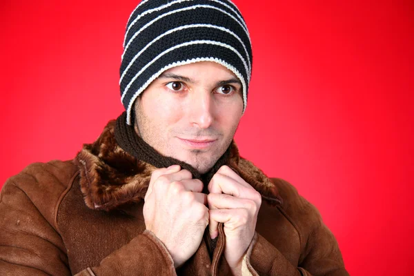 Man in a knit hat and leather jacket
