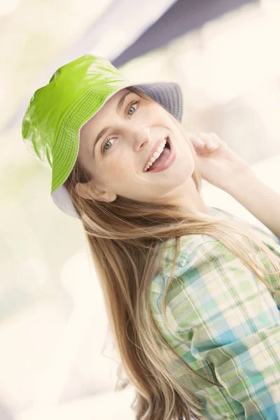 Woman in green hat smiling