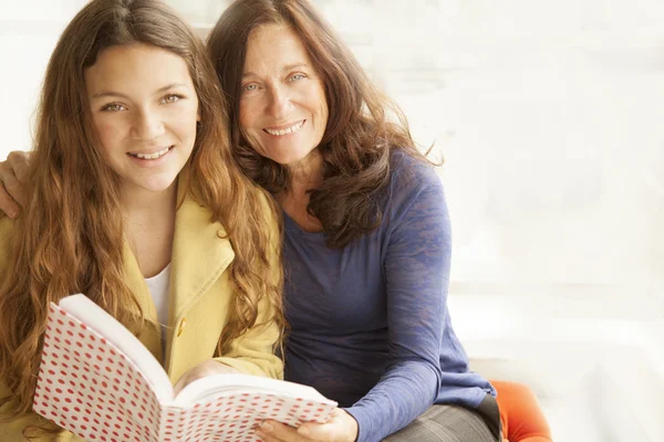 Mother and girl reading a book