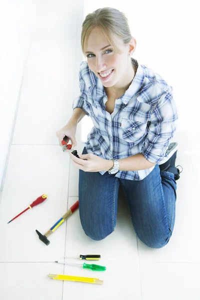 Woman working at home and using tools