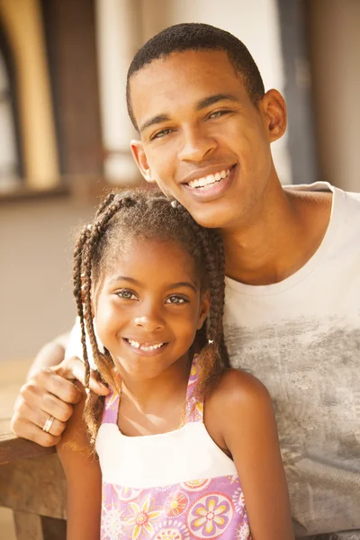 Man and little girl smiling